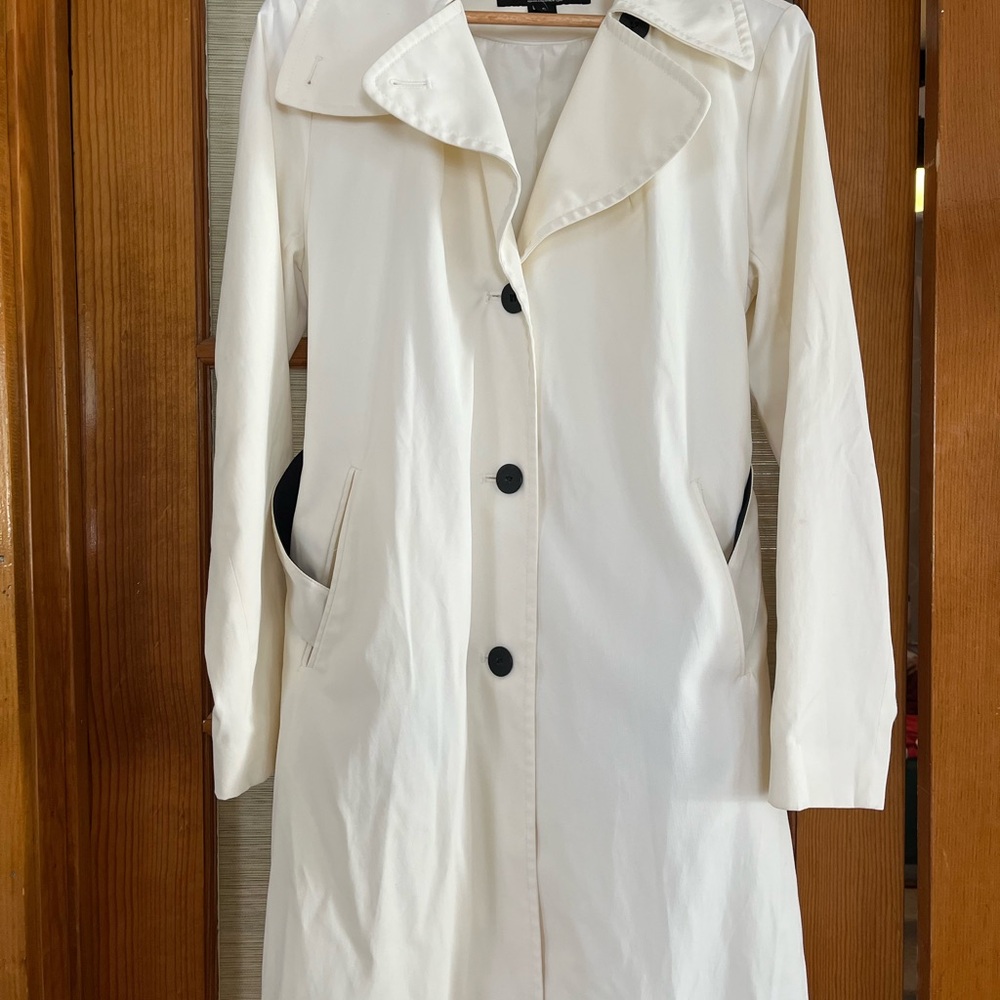 Elegant White Women's DKNY trench coat with reversible belt.